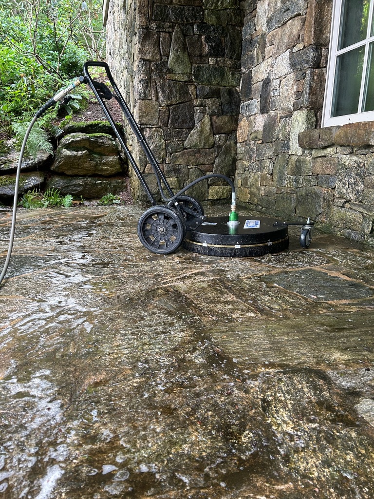 Concrete and masonry cleaning with commercial surface cleaner on natural stone patio
